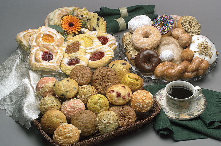 Variety of muffins and donuts displayed in the bakery section at Super One Foods.