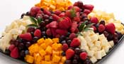 Cheese and fruit platter with various cheeses and fresh fruits